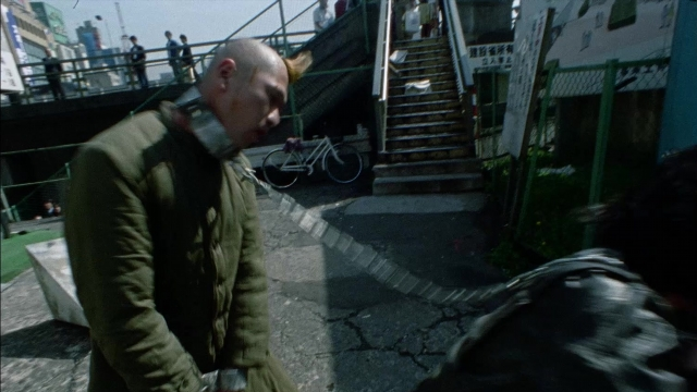 Wide shot frame from 964 Pinocchio — standing, street, bicycle