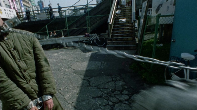 Wide shot frame from 964 Pinocchio — standing, walking, street