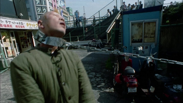 Wide shot frame from 964 Pinocchio — standing, walking, street
