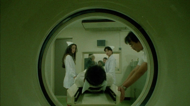 Frame from 964 Pinocchio — standing, room, bed