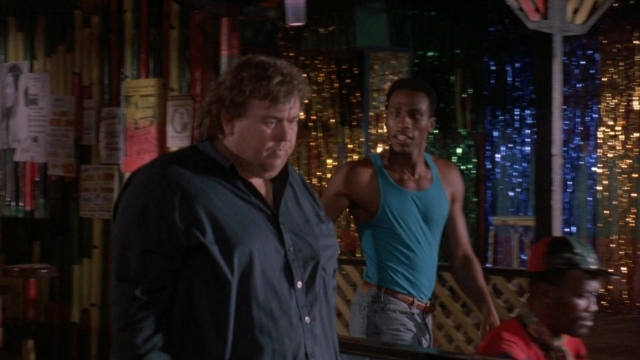 Wide shot frame from Cool Runnings — standing, room, hat
