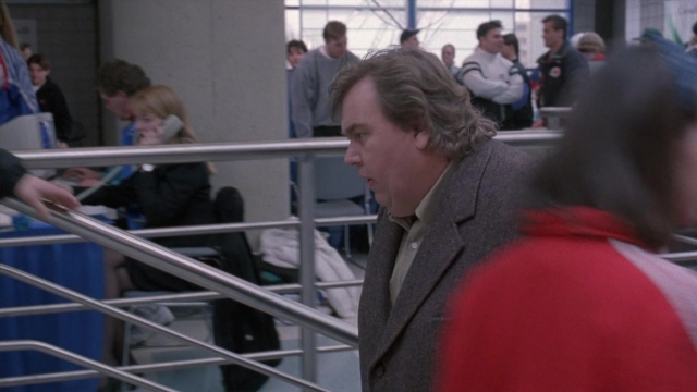 Wide shot frame from Cool Runnings — sitting, standing, walking