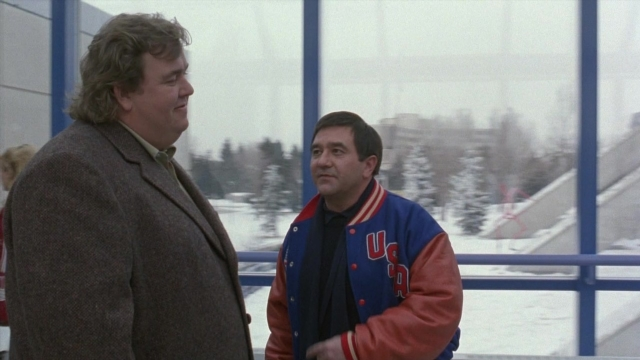 Wide shot frame from Cool Runnings — standing, dialogue, coat