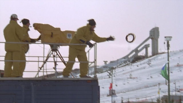 Wide shot frame from Cool Runnings — standing, snow, person