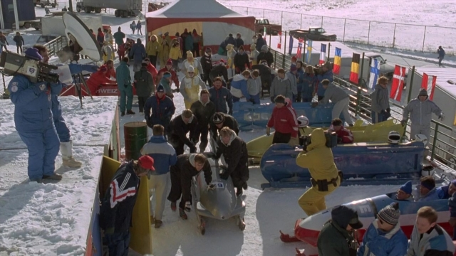Wide shot frame from Cool Runnings — car, shirt, snow