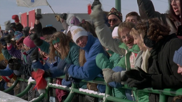 Wide shot frame from Cool Runnings — standing, hat, snow