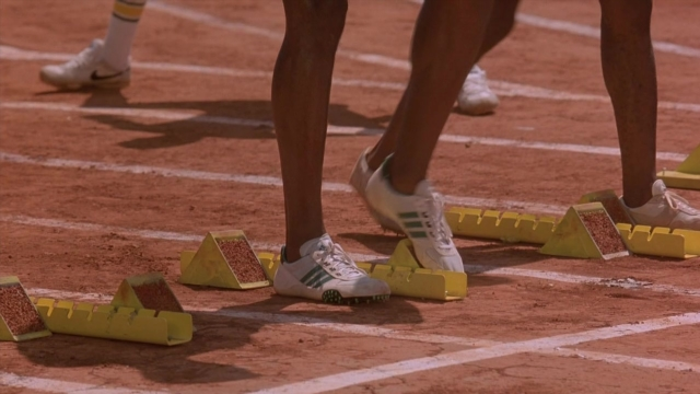 Wide shot frame from Cool Runnings — standing, person, footwear