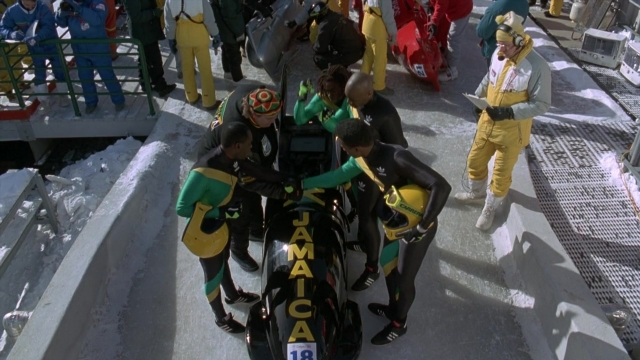 Wide shot frame from Cool Runnings — standing, car, person