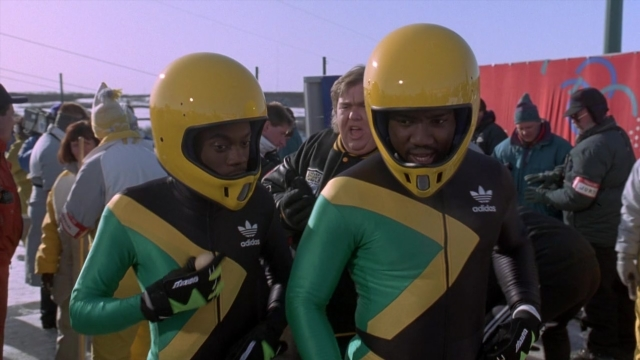 Wide shot frame from Cool Runnings — standing, hat, person