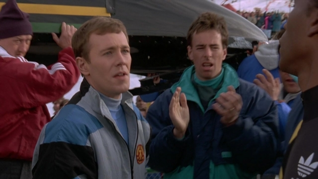 Wide shot frame from Cool Runnings — standing, dialogue, jacket