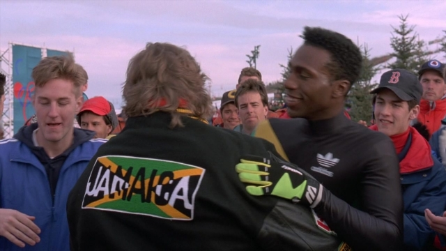Wide shot frame from Cool Runnings — standing, dialogue, hand