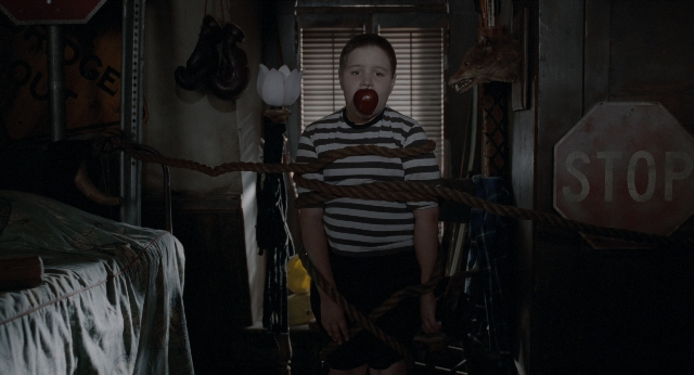 Wide shot frame from The Addams Family — standing, room, bed