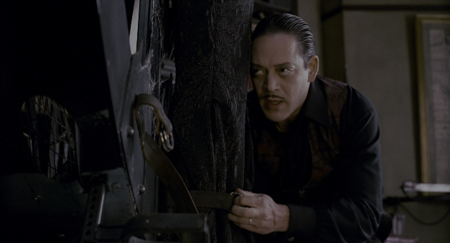 Wide shot frame from The Addams Family — room, hand, face