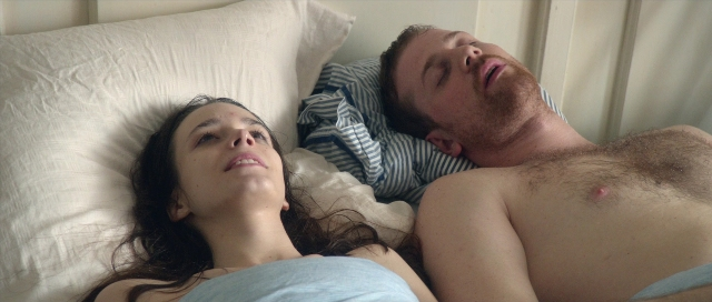 Frame from Nymphomaniac: Vol. I — bed, beard, pillow