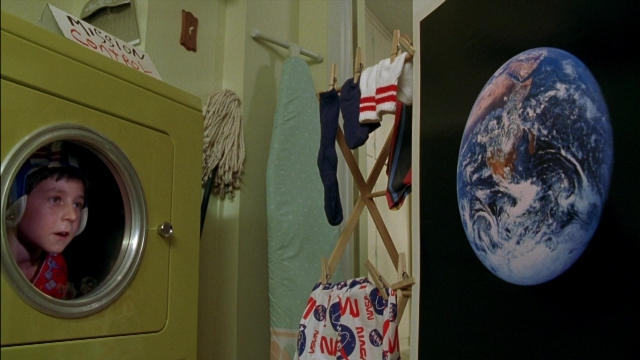 Wide shot frame from Rocketman — room, hat, shirt
