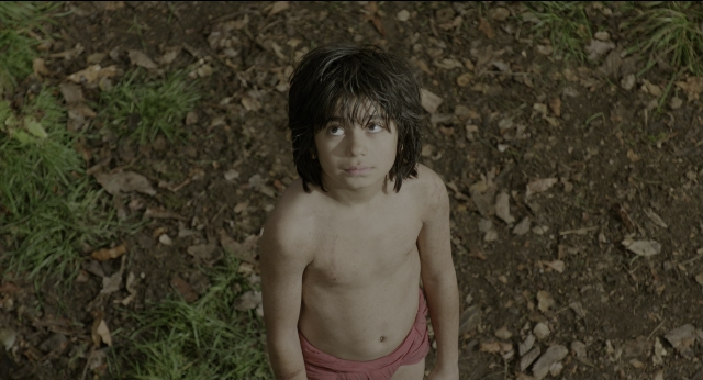 Wide shot frame from The Jungle Book — standing, bed, face