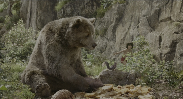 Wide shot frame from The Jungle Book — sitting, standing, hand