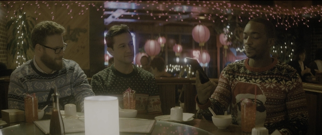 Wide shot frame from The Night Before — sitting, table, dialogue