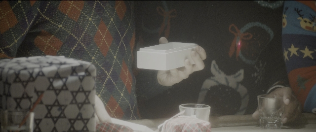 Wide shot frame from The Night Before — sitting, room, table