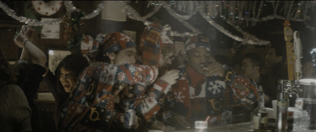 Wide shot frame from The Night Before — clock, person, human face