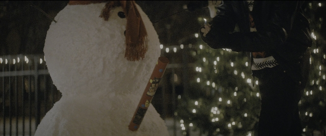 Wide shot frame from The Night Before — standing, hand, night