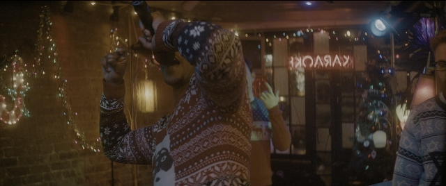 Wide shot frame from The Night Before — room, shirt, face