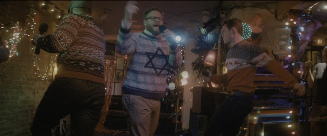 Wide shot frame from The Night Before — standing, hand, person
