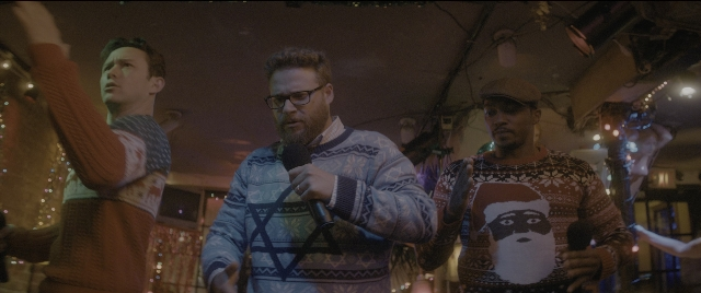 Wide shot frame from The Night Before — standing, room, dialogue
