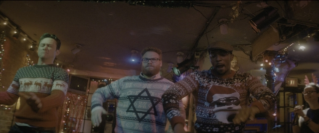 Wide shot frame from The Night Before — standing, room, hat