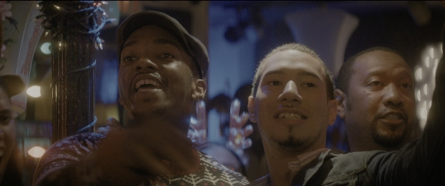 Medium shot frame from The Night Before — standing, room, dialogue