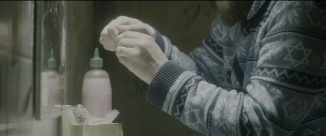 Wide shot frame from The Night Before — standing, room, hat