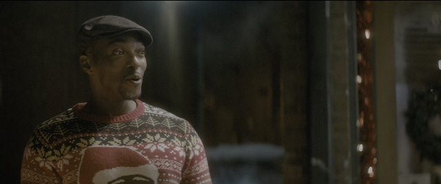 Wide shot frame from The Night Before — standing, room, hat