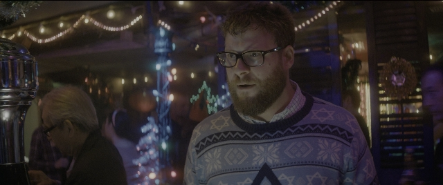 Medium shot frame from The Night Before — standing, room, beard