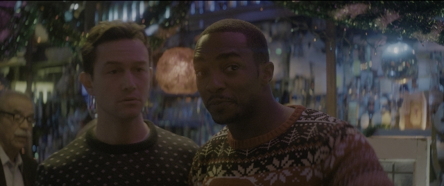Medium shot frame from The Night Before — standing, room, suit