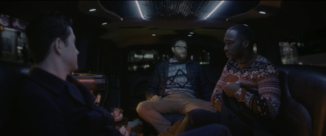 Medium shot frame from The Night Before — sitting, room, dialogue