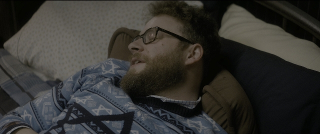 Wide shot frame from The Night Before — bed, person, human face