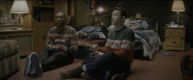 Medium shot frame from The Night Before — sitting, room, dialogue