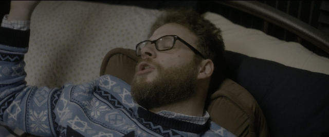 Wide shot frame from The Night Before — bed, person, human face