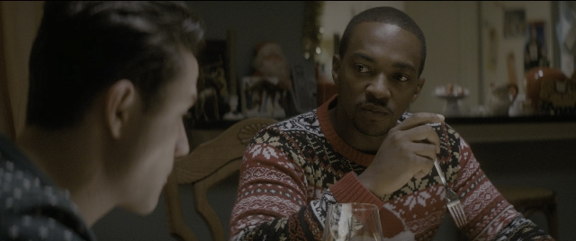 Medium shot frame from The Night Before — sitting, room, table
