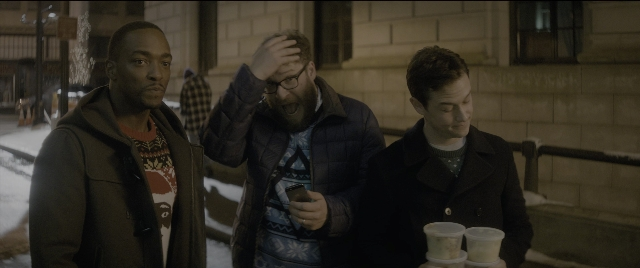 Wide shot frame from The Night Before — standing, phone, street