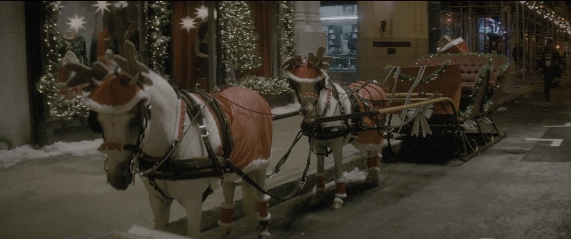 Wide shot frame from The Night Before — street, hat, horse