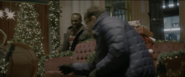 Wide shot frame from The Night Before — sitting, standing, room