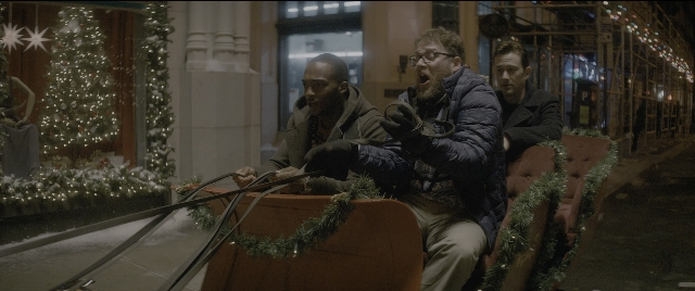 Wide shot frame from The Night Before — sitting, night, train
