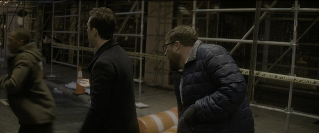 Wide shot frame from The Night Before — standing, dialogue, coat