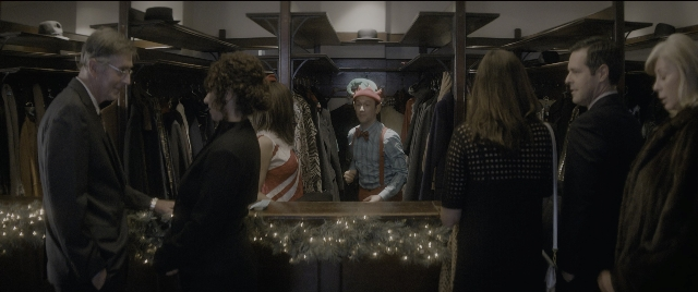 Wide shot frame from The Night Before — standing, hat, suit