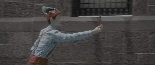 Wide shot frame from The Night Before — standing, street, hat