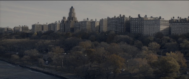 Wide shot frame from The Night Before — street, water, tower