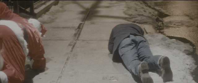 Wide shot frame from The Night Before — street, hat, water