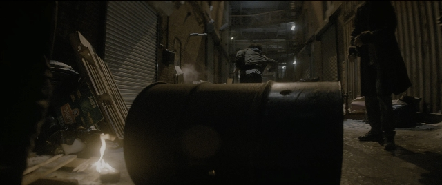 Wide shot frame from The Night Before — standing, night, barrel