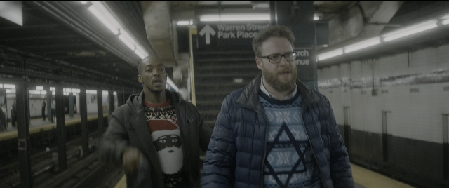 Wide shot frame from The Night Before — standing, street, beard